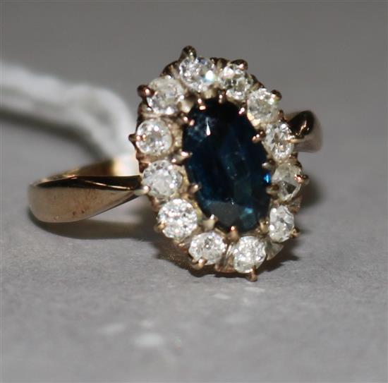 A sapphire and diamond cluster ring, yellow metal setting.